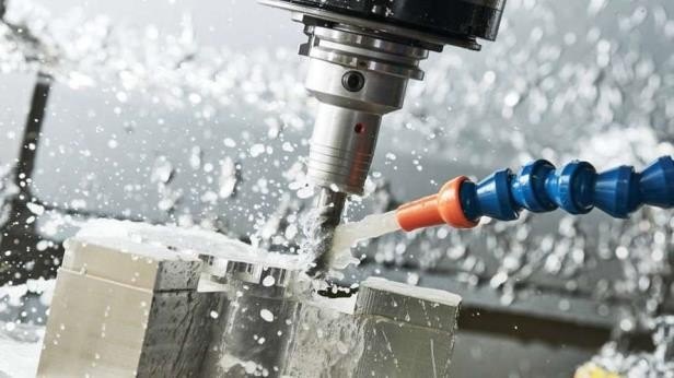 End mill cutting a steel part under flood coolant