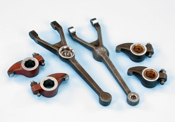 Machined and induction hardened shifter forks and rocker arms fitted with bronze bushes